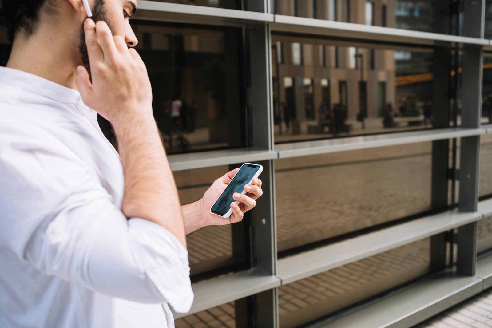 businessman-doing-video-conference-call-smartphone-talking-with-bluetooth-handsfree-device
