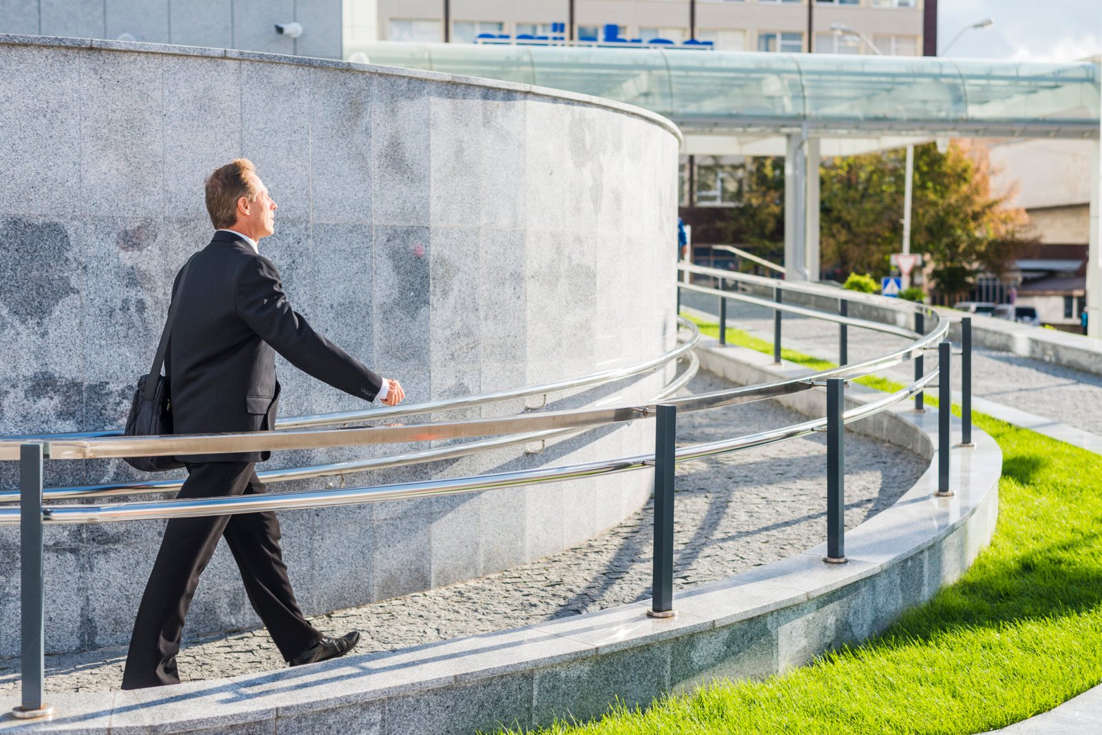 side-view-businessman-walking-near-railing